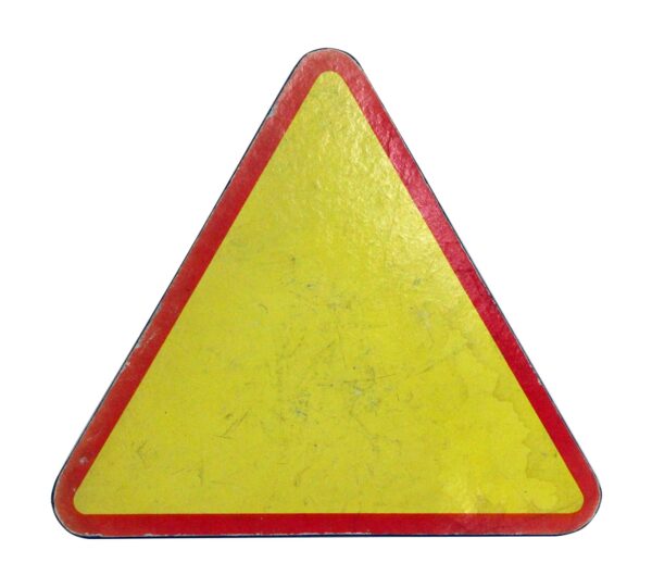 Triangular caution sign with a yellow center and orange border, shown as a close-up of the upper portion.