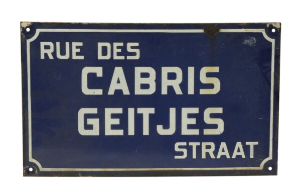 Vintage metal sign in blue and white with the text “RUE DES CABRIS GEITJES STRAAT” and four corner mounting holes.