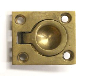 Rectangular brass recessed cabinet pull with four mounting holes and a rounded finger recess.
