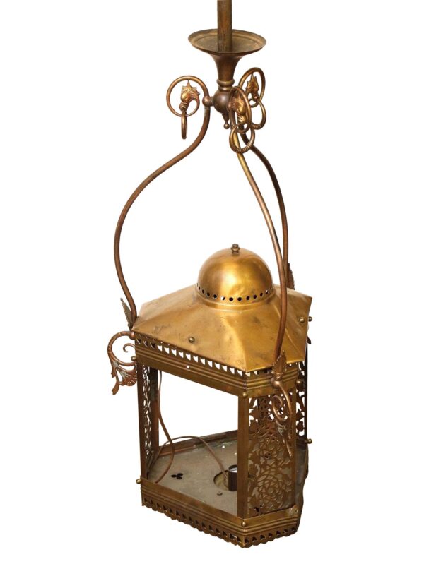 Brass pendant ceiling lantern with griffin head details and an ornate open frame, shown from a slight angle.