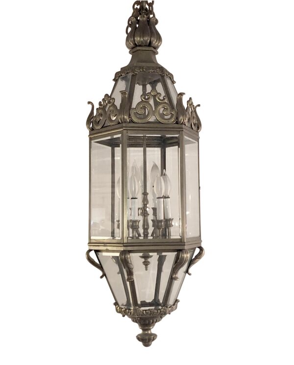 Antique ceiling lantern with clear beveled glass, ornate cast bronze details, and 12 candlestick lights inside.
