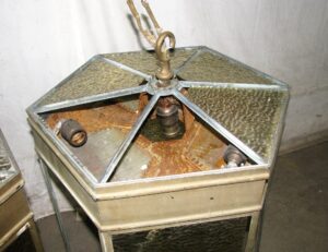 Hexagonal pendant lantern with several glass panels missing and a central hanging loop visible.