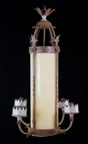 Gothic ceiling lantern with a tall yellow glass center, wrought iron frame, and five candle-style sockets, shown in a front view with aged rust details.