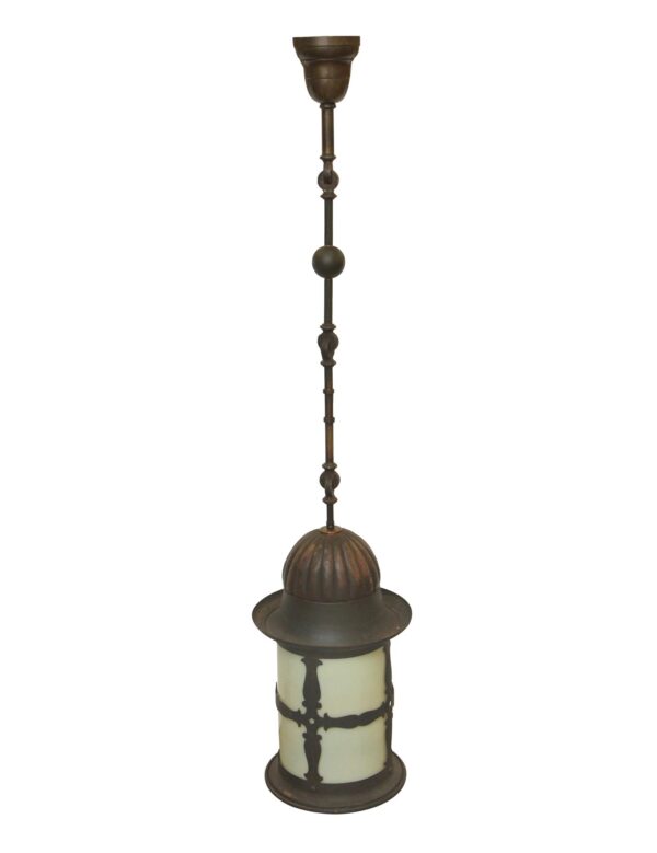 Colonial ceiling lantern with a fluted dome, ornate tubing, and a milk glass shade.