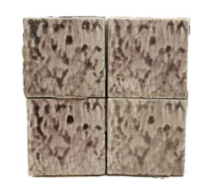 Set of four square ceramic wall tiles with a pale mottled purple crackled surface shown in a close-up arrangement.