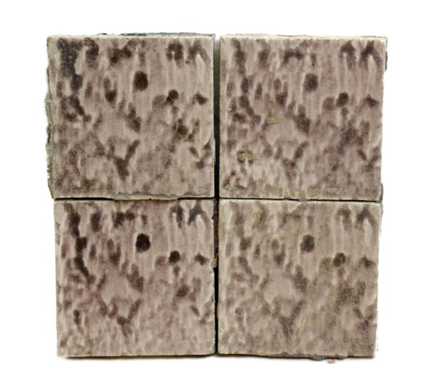 Set of four square ceramic wall tiles with a pale mottled purple crackled surface shown in a close-up arrangement.