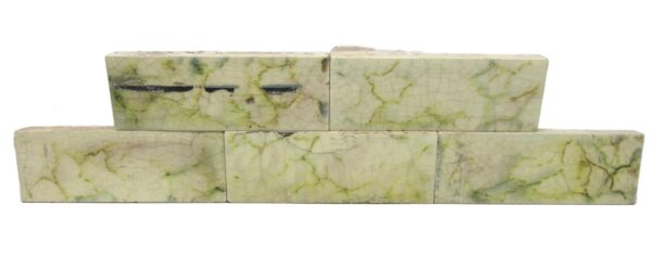 Set of five ceramic tiles with a green, multi-colored, and white crackled surface, shown stacked in two rows with visible age-related chips and scrapes.