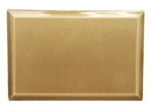 Plain tan beveled ceramic wall tile with a crackled surface and visible age-related wear.