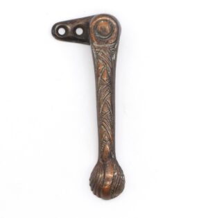 Antique window latch with a decorative design and two mounting holes, shown in a close-up view with the catch omitted.
