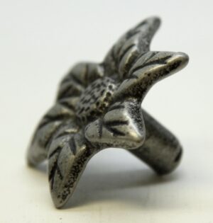 Close-up of a floral cabinet knob with a threaded mounting stem and black gray finish.