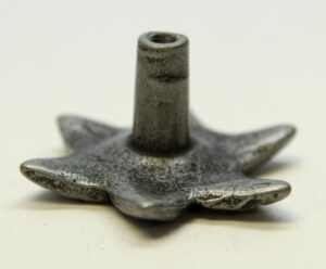 Close-up of a floral drawer knob with a black finish and raised leaf-like details.