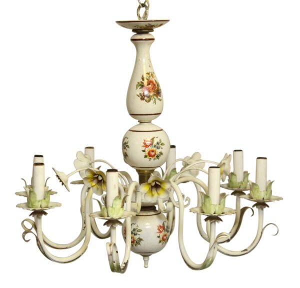 White French Country chandelier with eight arms, a floral porcelain center, and candle-style light sockets.