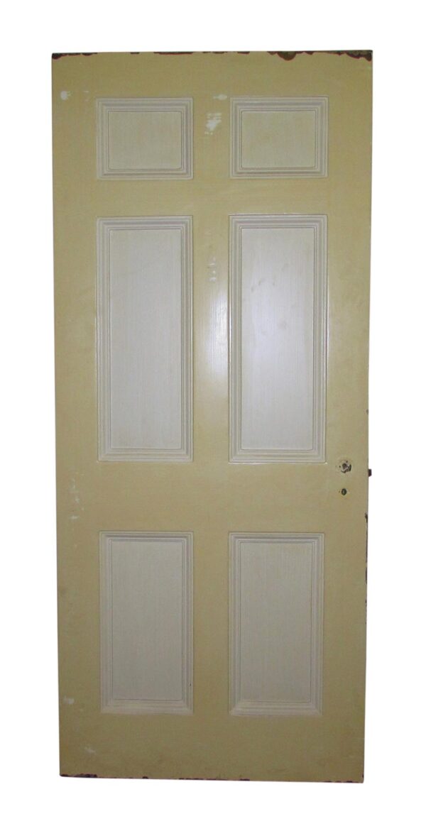 Six-panel metal door with a yellow face and white recessed panels, shown upright and filling the frame.