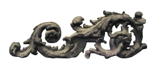 Decorative cast iron floral building piece with an ornate scrolling shape and openwork details.