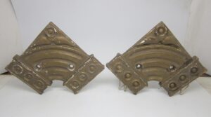 Pair of vintage cast iron wall mount brackets shown as a pair, each with a corner shape and surface wear.