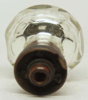 Close-up of a faceted mercury glass door knob with a wide brass shank, showing the front opening and etched details.