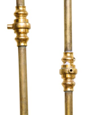 Pair of brass cremone bolts shown in close-up, with polished brass fittings on two vertical rods.