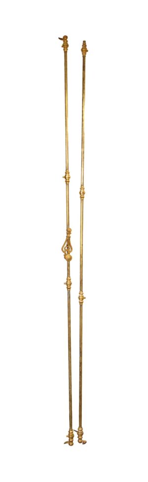 Pair of brass double door cremone bolts shown side by side, with ornate finials and long narrow rods.
