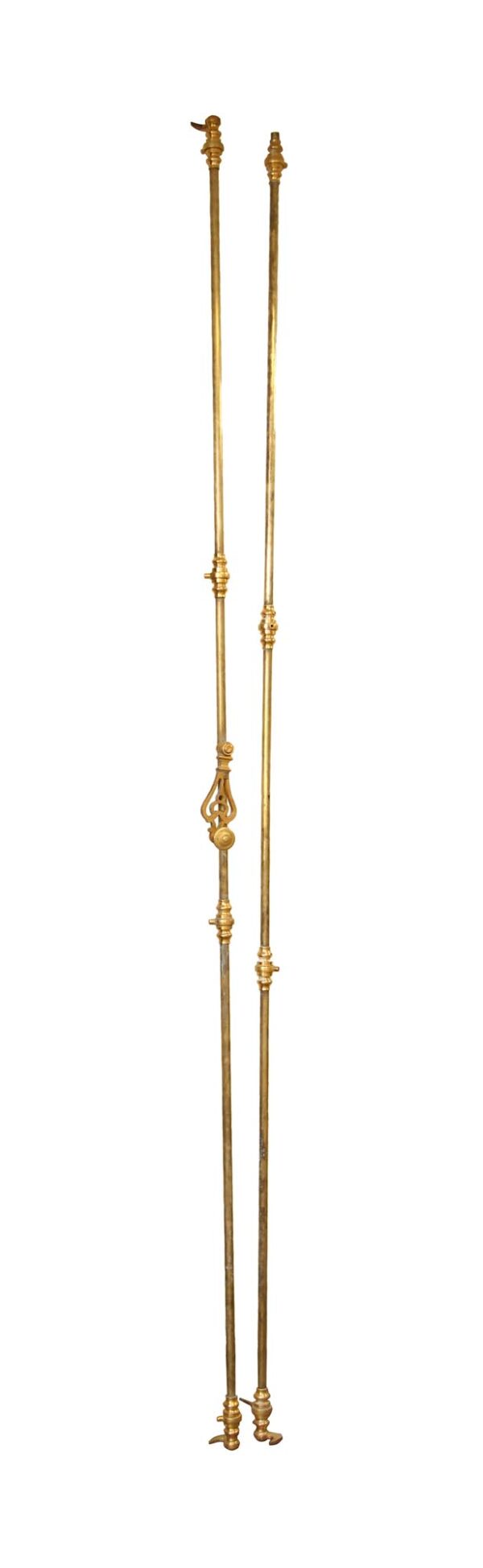 Pair of brass double door cremone bolts shown side by side, with ornate finials and long narrow rods.