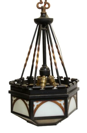 Gothic pendant light with black and copper finish, showing a hexagonal frame, arched white glass panels, and a missing bottom glass panel.