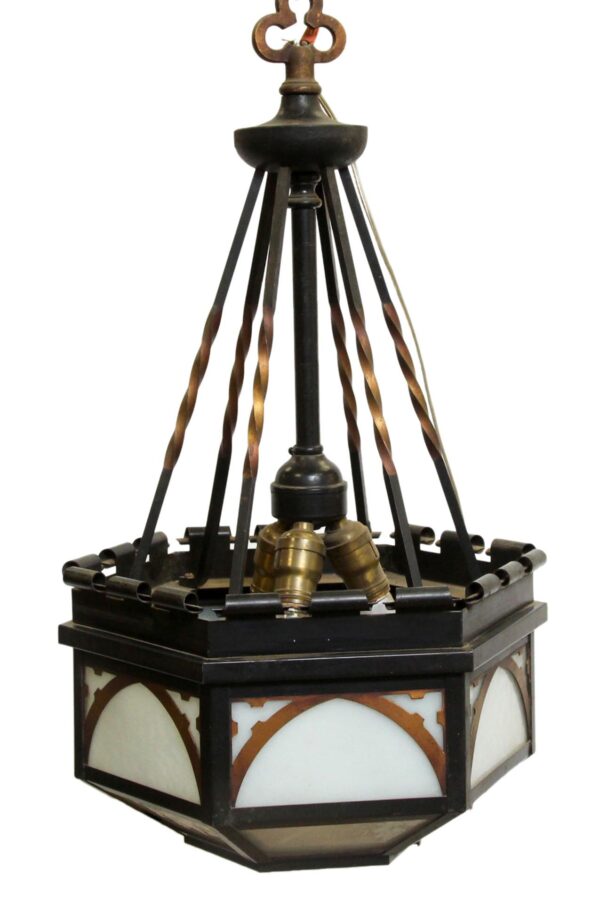 Gothic pendant light with black and copper finish, showing a hexagonal frame, arched white glass panels, and a missing bottom glass panel.