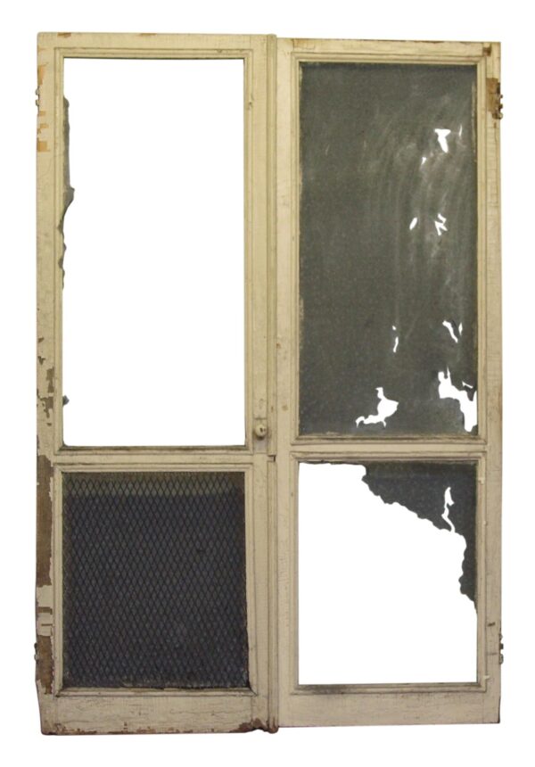 White double door with two panels, showing one screened lower panel and one missing upper panel, with worn wood edges and damaged screen or glass.