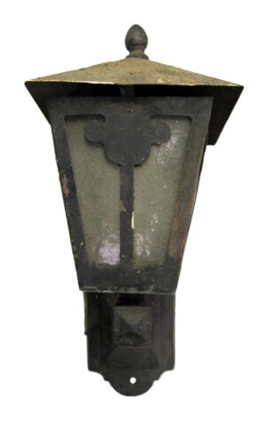 Arts and Crafts exterior wall sconce in wrought iron with a peaked cap and frosted glass panels, shown from the front.