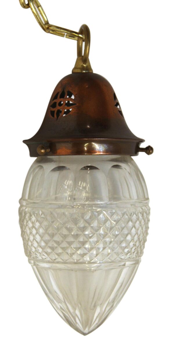 Pendant light with a copper-finished fitter and clear etched glass globe, shown hanging with a chain connection.