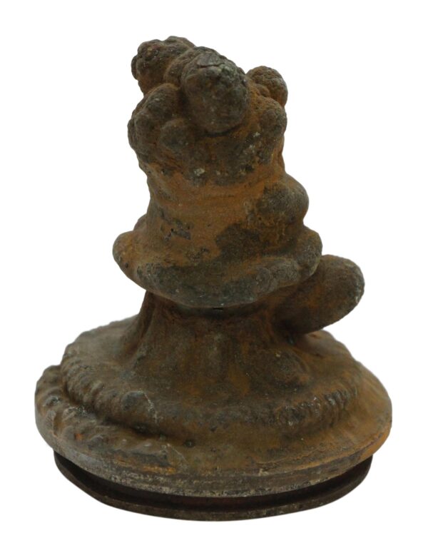 Cast iron decorative teddy bear mold shown from the front with a rounded base and heavily rusted surface.