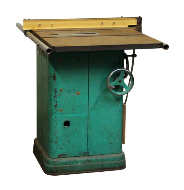 Vintage Rockwell saw machine with a green metal cabinet, medium wood-tone top, and a handwheel on the right side.