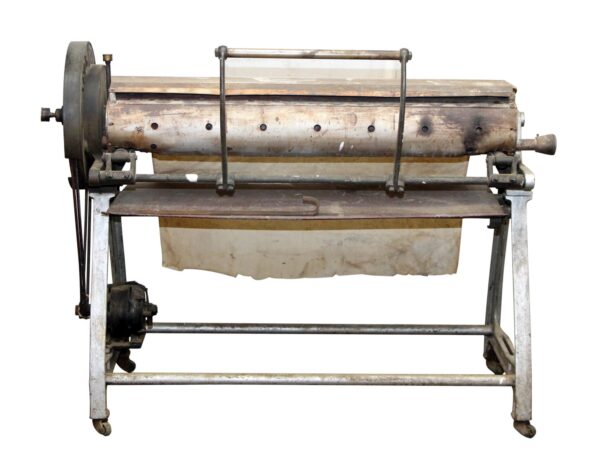 Vintage gray cast iron ironer machine on a wheeled stand, shown in full with roller, side crank, and lower support bar visible.