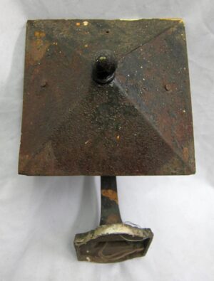 Arts and Crafts wrought iron exterior wall sconce with a square top panel, grayish green paint, and a small bottom glass shade.