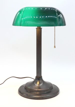 Antique bankers desk lamp with a green and white Emeralite shade, fluted brass stem, and pull chain switch.