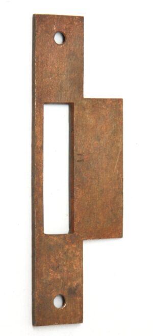 Antique brass mortise lock strike plate cover with a long rectangular cutout and two screw holes.