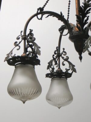 Victorian chandelier with ornate brass arms and frosted glass shades, shown with two of the four down lights visible.