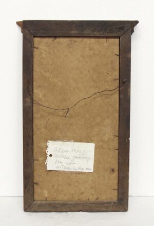 Back view of a framed mirror with a dark wooden frame, showing the reverse painting backing and a handwritten paper label attached near the bottom.