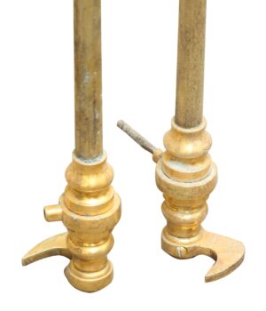 Pair of brass double door cremone bolts shown as a pair, with long rods and curved locking handles, in polished brass finish.