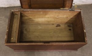 Open wooden cedar chest with a dark wood tone, showing the empty interior, side divider, and visible wear.