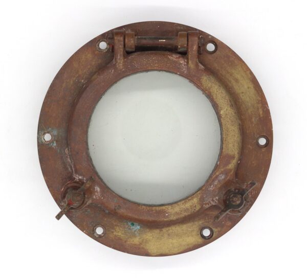 Antique brass round porthole window with clear glass, showing a hinged top and latch handles.