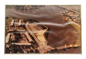 Framed aerial photo of a river and bridge, shown in a metal frame with glass cover.