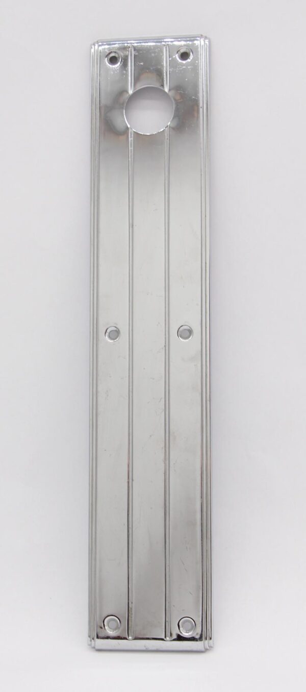 Art Deco door push plate with a circular lock insert, shown in a long vertical view with four mounting holes.