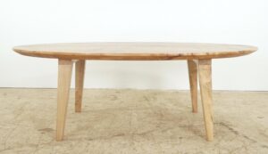 Close-up of a maple and clear resin coffee table top with a river-like inlay and oval edge.