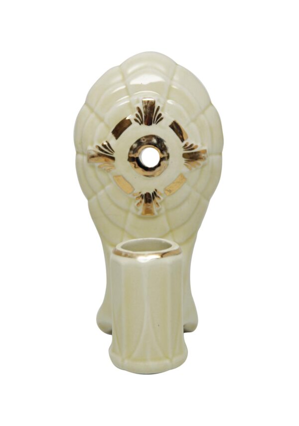Traditional porcelain wall sconce with an ivory-toned body, gold detail, and a centered opening above the socket area.