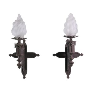 Pair of Gothic wall sconces with frosted flame-shaped glass shades and ornate cast iron mounts shown front and side by side.
