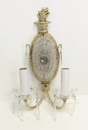 French-style two-arm wall sconce with gilt bronze and clear crystal beading, shown with candle cups and hanging prisms.