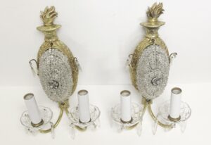 Pair of restored French wall sconces with gilt bronze frames, clear beaded crystal centers, and two candle-style bulb holders on each fixture.