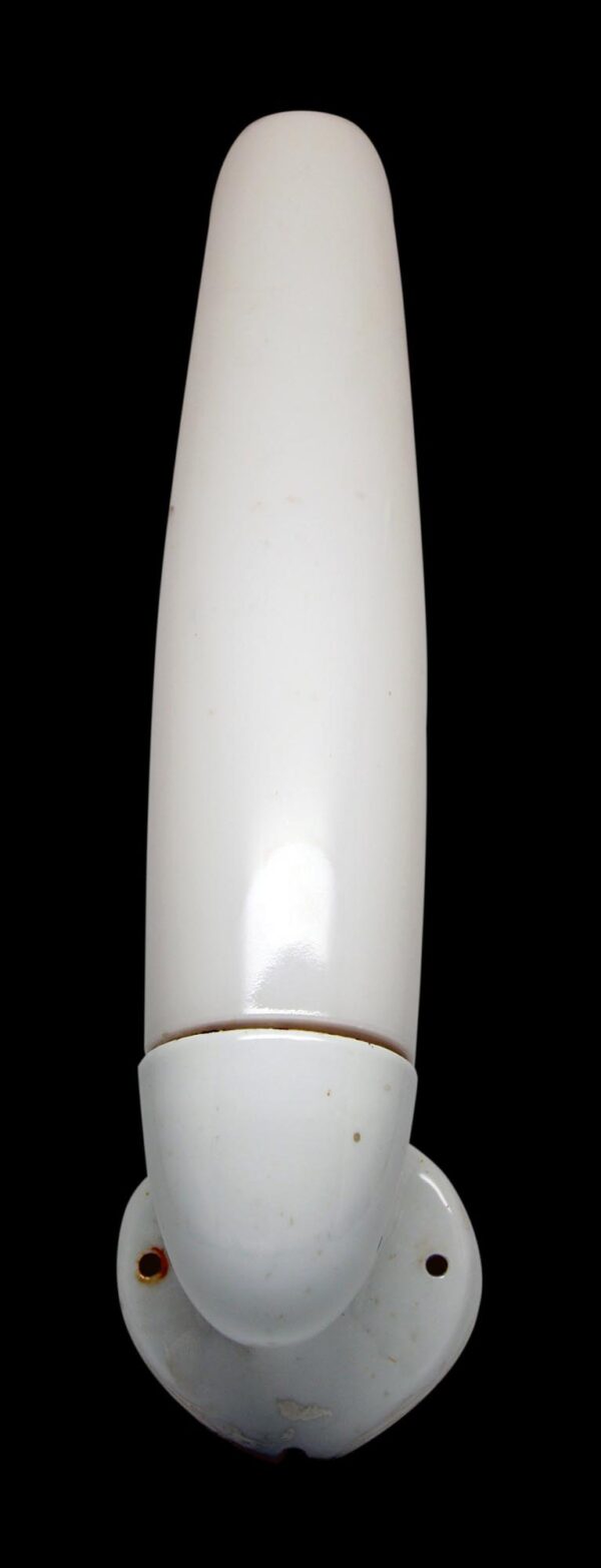 Tall milk glass wall sconce with a white porcelain base and rounded mounting screws.