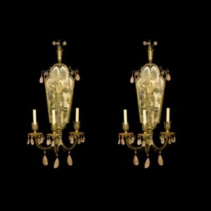 Pair of Victorian wall sconces with mirrored backplates, three candle-style lights each, and crystal drops.