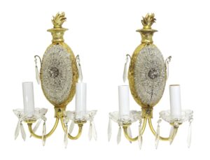Pair of restored French wall sconces with two arms each, featuring gilt bronze, clear crystal beading, and candle-style bulb holders.