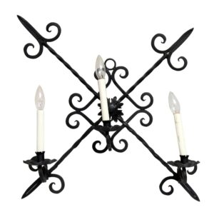 Colonial black iron wall sconce with three candle-style lights and decorative curled arms.
